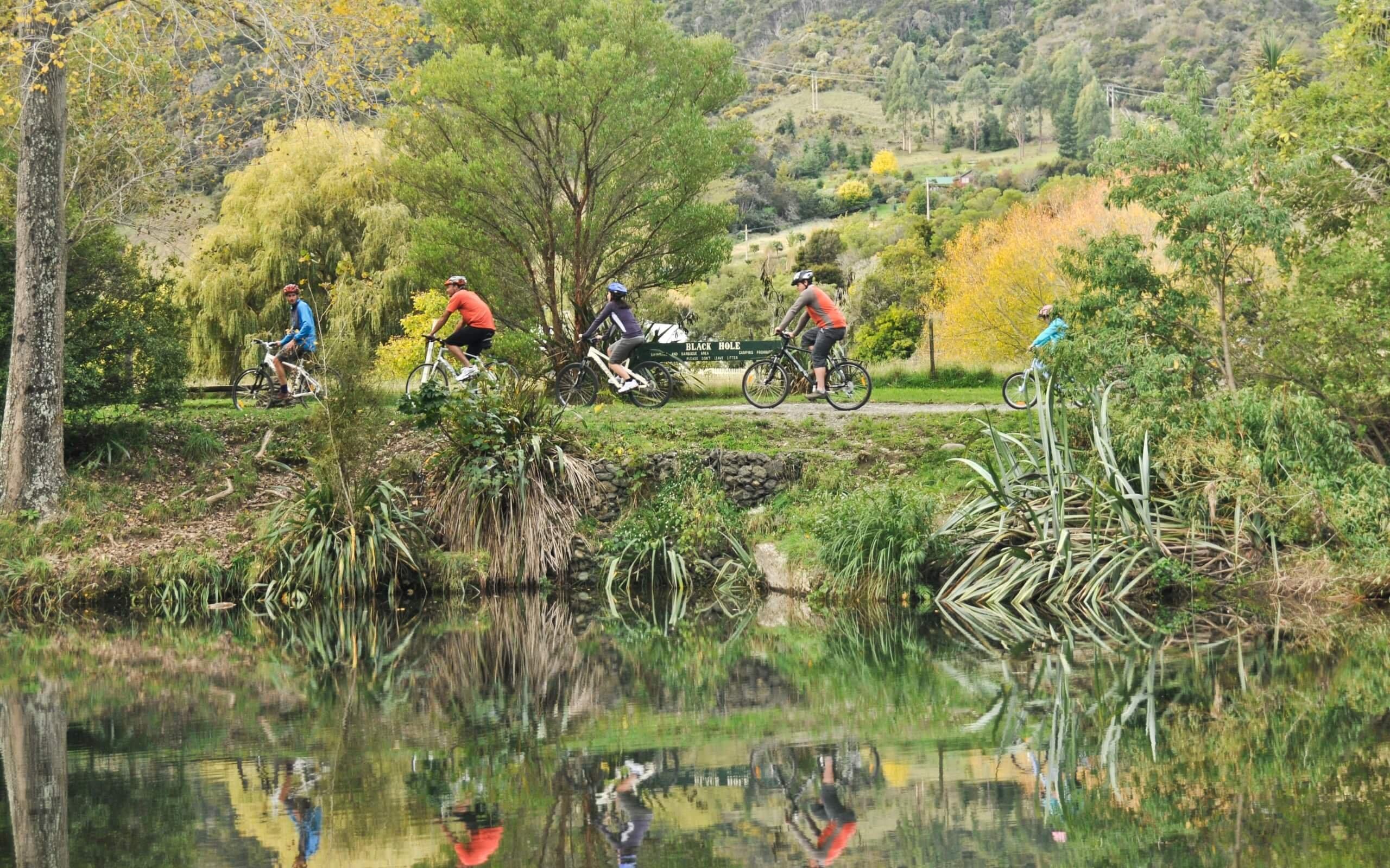 Cyclists at black hole along maitai river v2