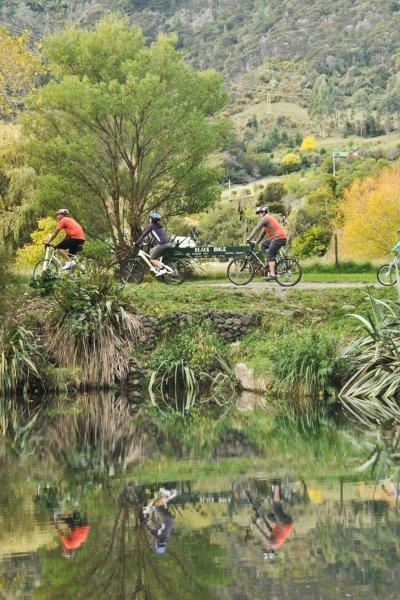 Cyclists at black hole along maitai river