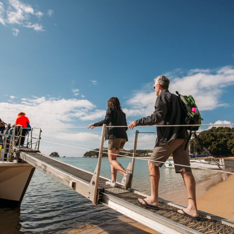 Couple Boarding Wilsons Boat Kaiteriteri