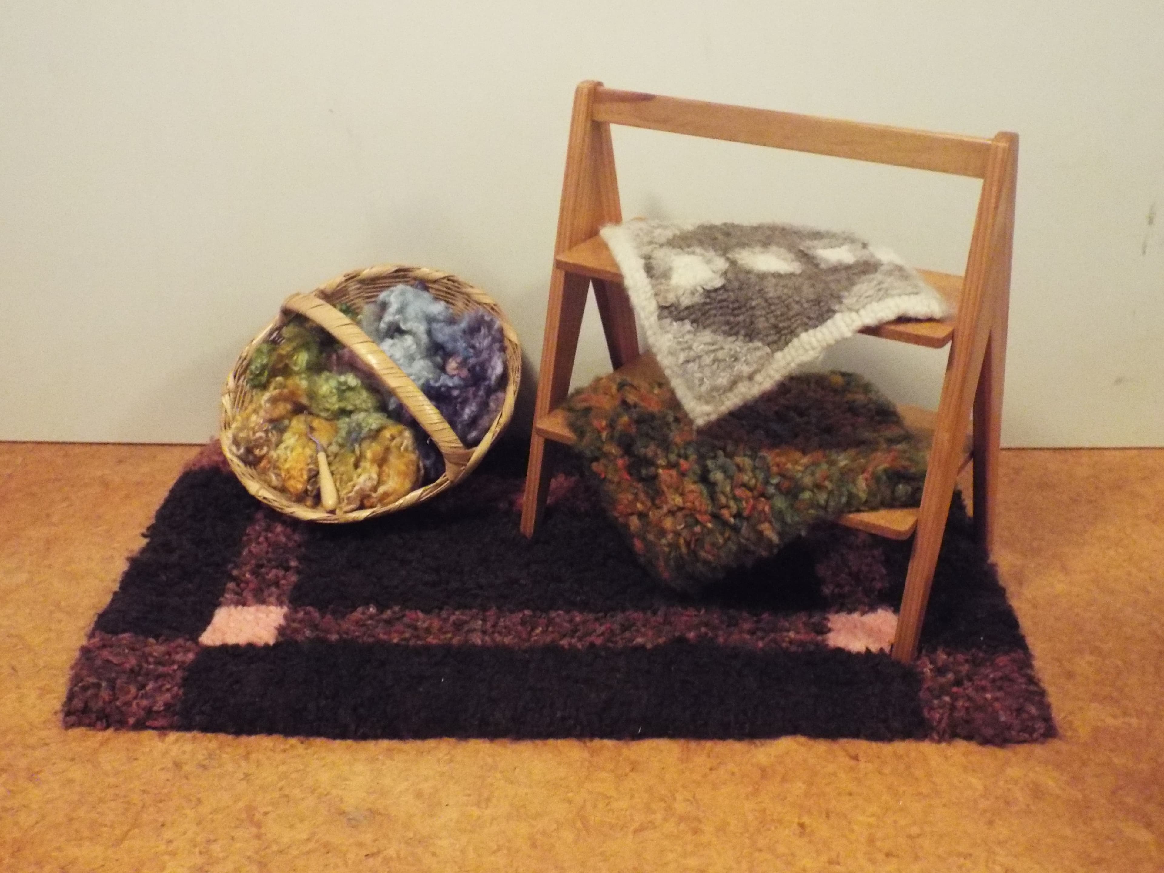 Student's work made at our Heirloom Hooked Fleece Rug Making Workshop, displayed alongside beautiful dyed New Zealand wools.