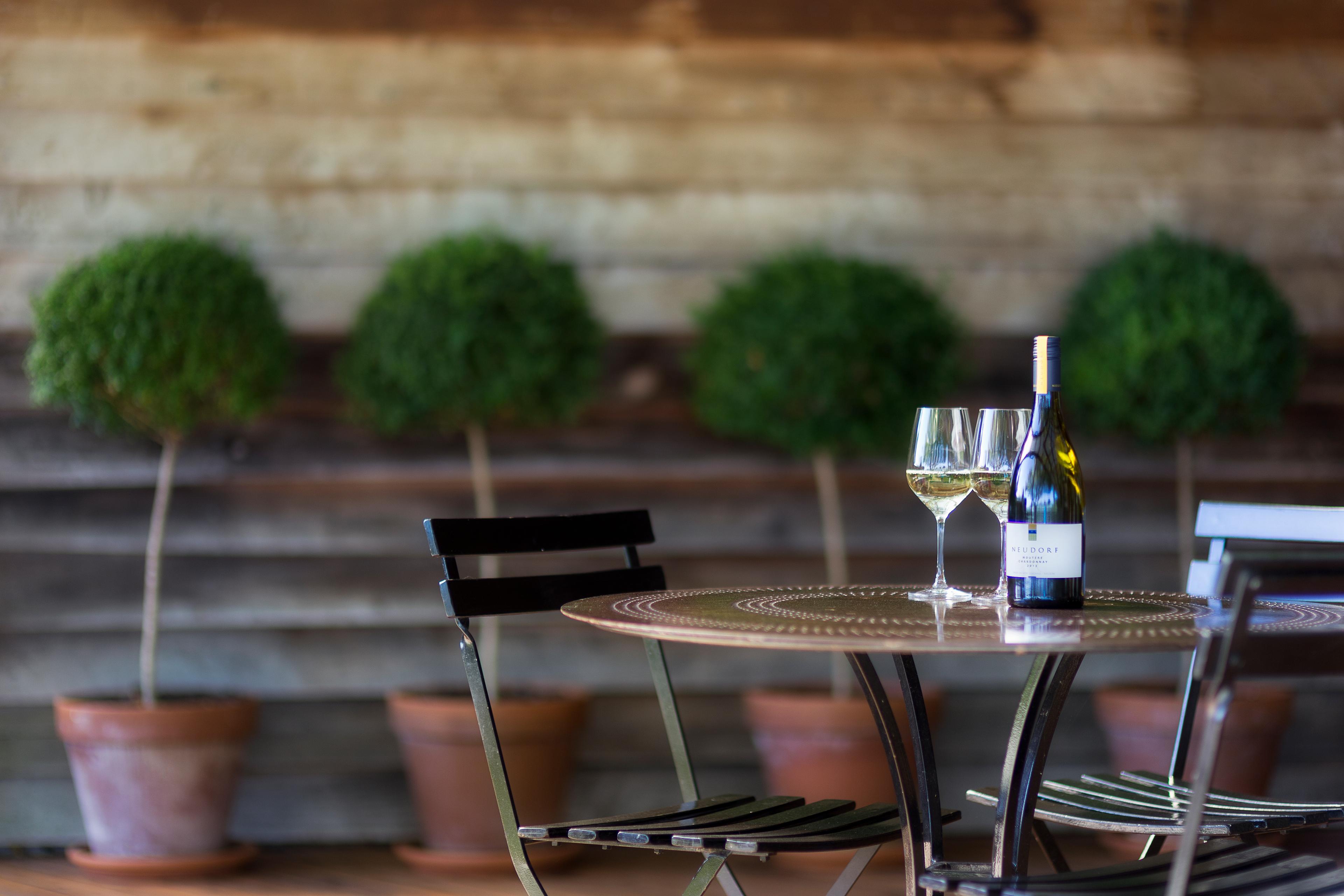 A glass of Moutere Chardonnay in the cellar door garden at Neudorf.