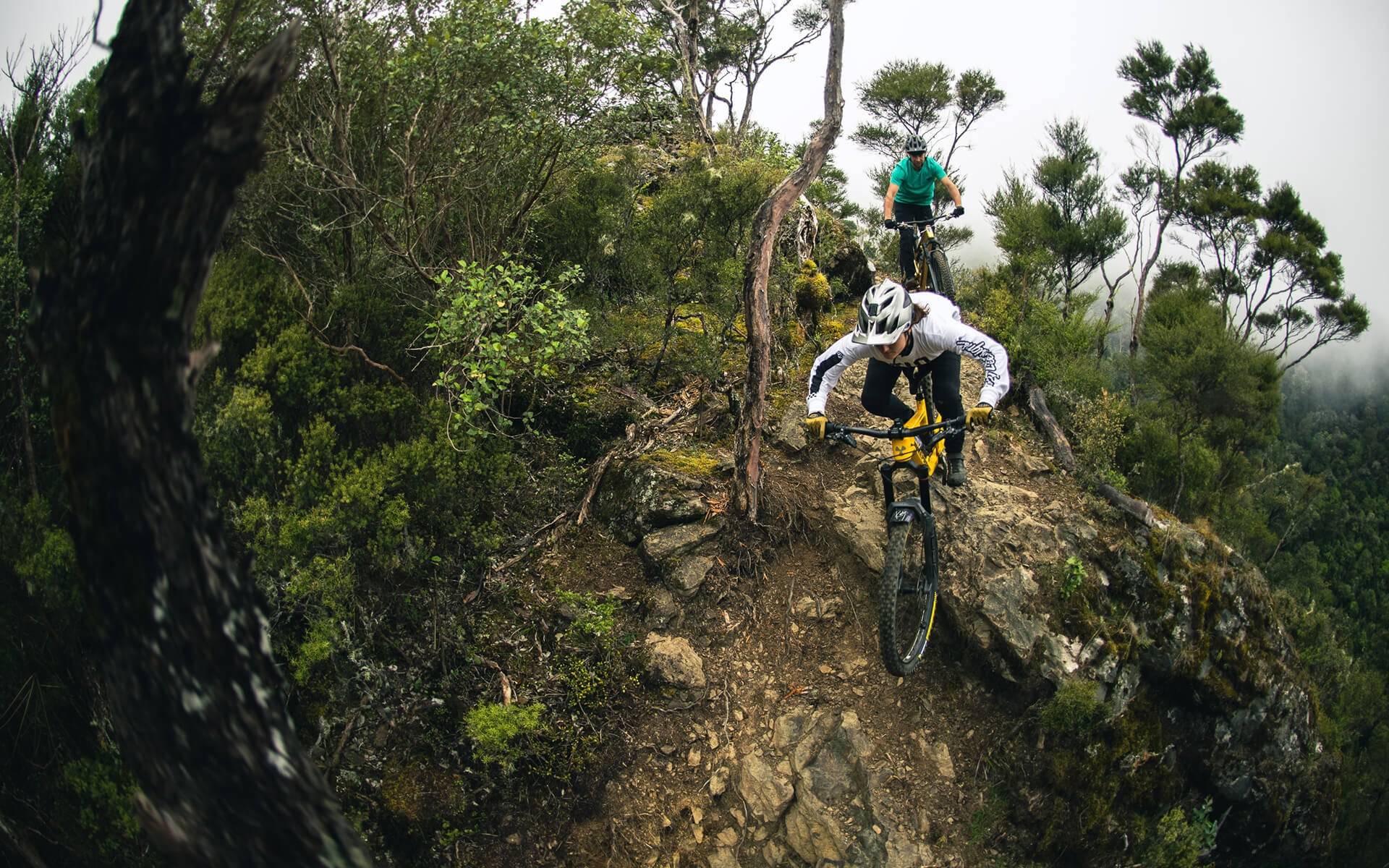 Joe follows Katy off a rock drop at Gamble, way up in the clouds at Cable Bay Adventure Park.