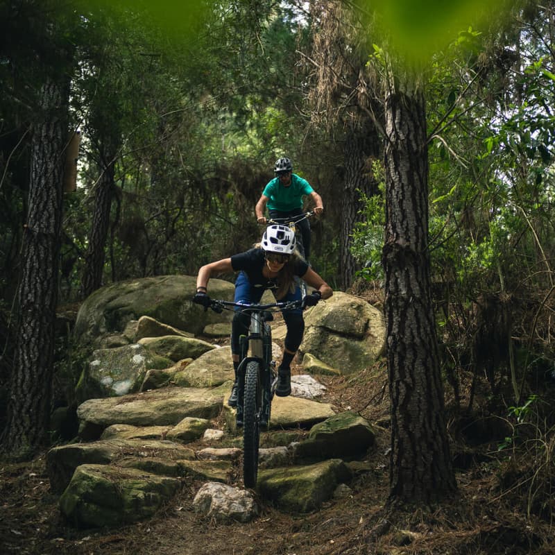 Joe follows Rae through the rock garden at Kaiteriteri MTB Park.