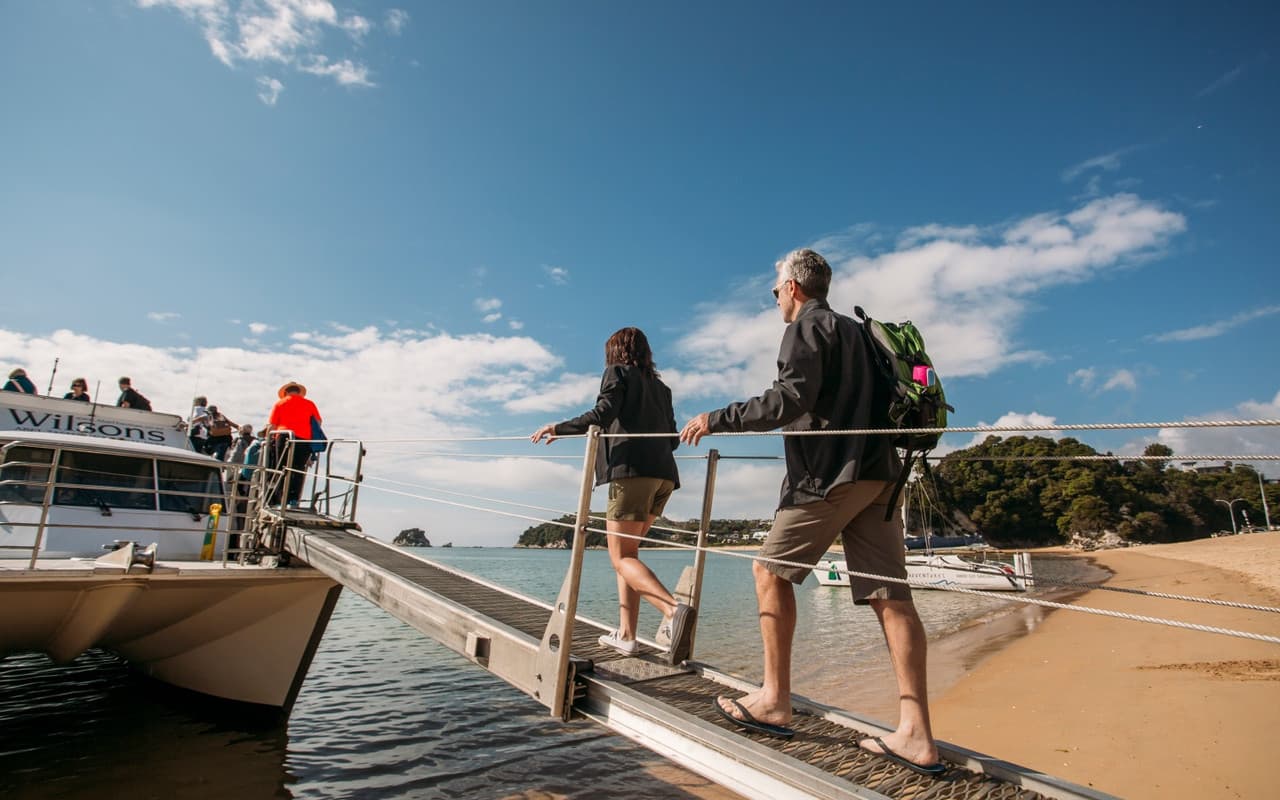 Couple Boarding Wilsons Boat Kaiteriteri