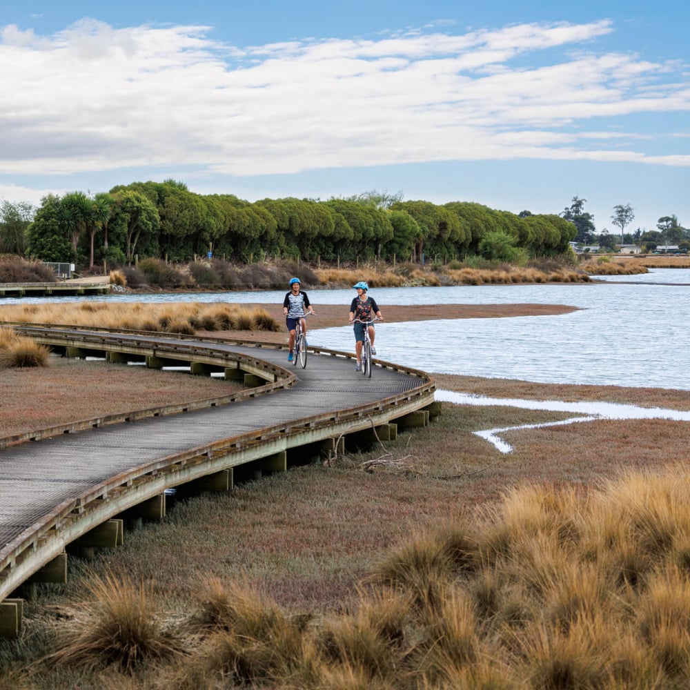 Cruise the trails around Waimea Inlet for a laid-back ride with epic coastal views.